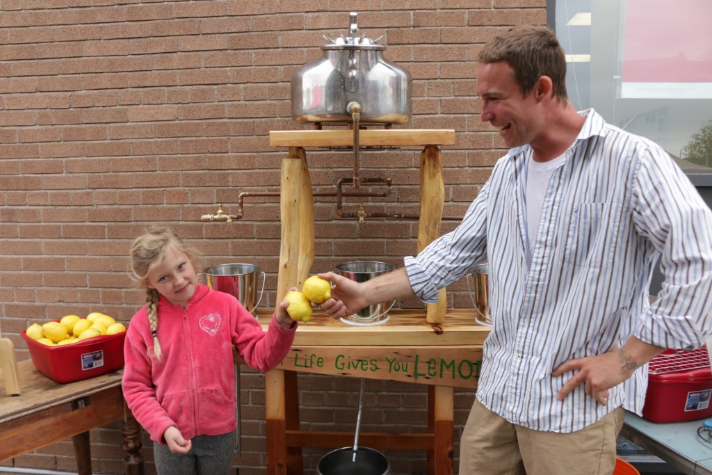 Man and his daughter with lemons