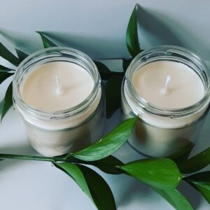Two candles with greenery