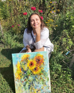 Woman holding painting of sunflowers