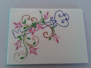 Hand stitched card with key and flowers