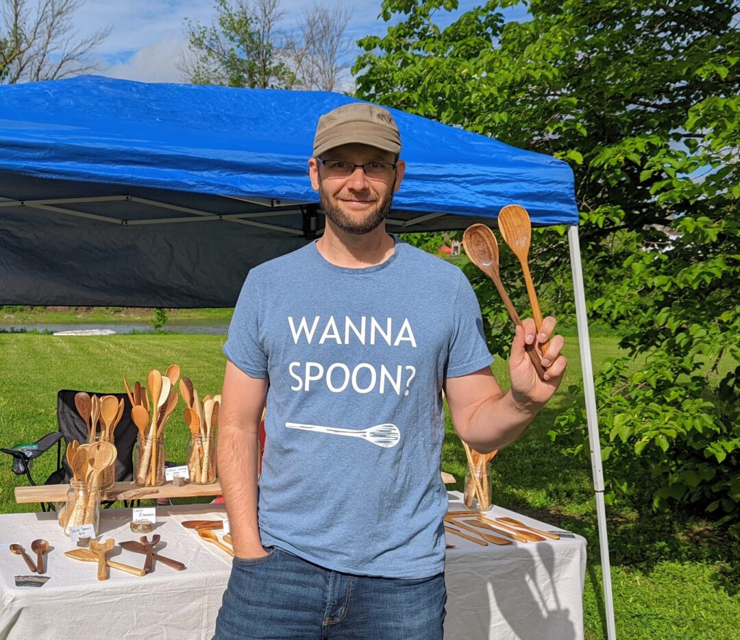 Man holding wooden spoons
