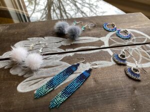 Beaded earrings and feather
