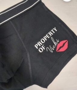 Black shorts with Property of Vicki with red lips
