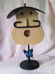 Guitar faced object with mustache and butterfly